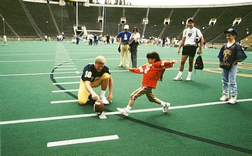 Naomi kicking football